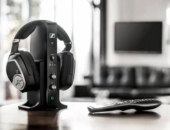 Sennheiser RS 195 wireless TV headphones resting on their charging stand