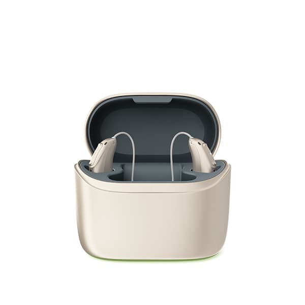 A pair of rechargeable hearing aids sitting in an open charging case