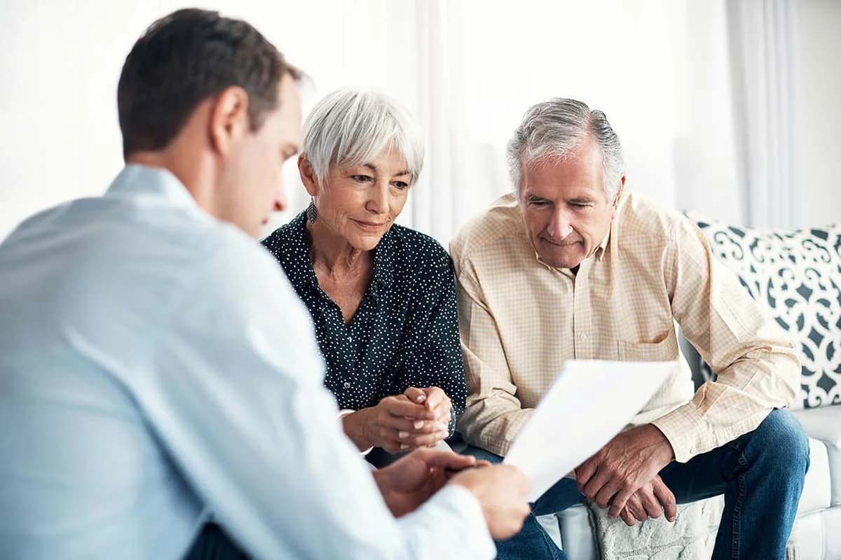 An audiologist going through hearing results with an older couple