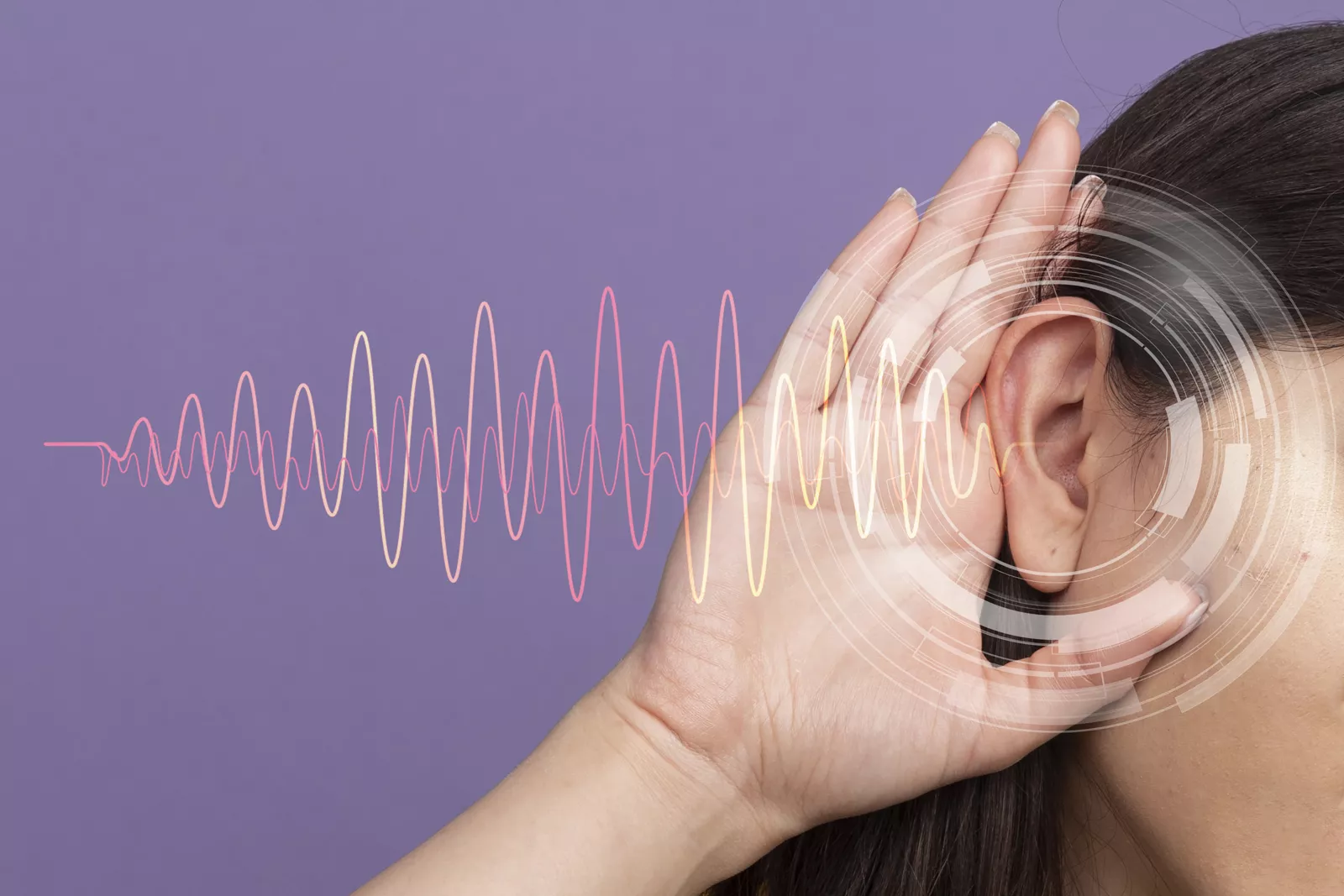 A man holding his ear in discomfort