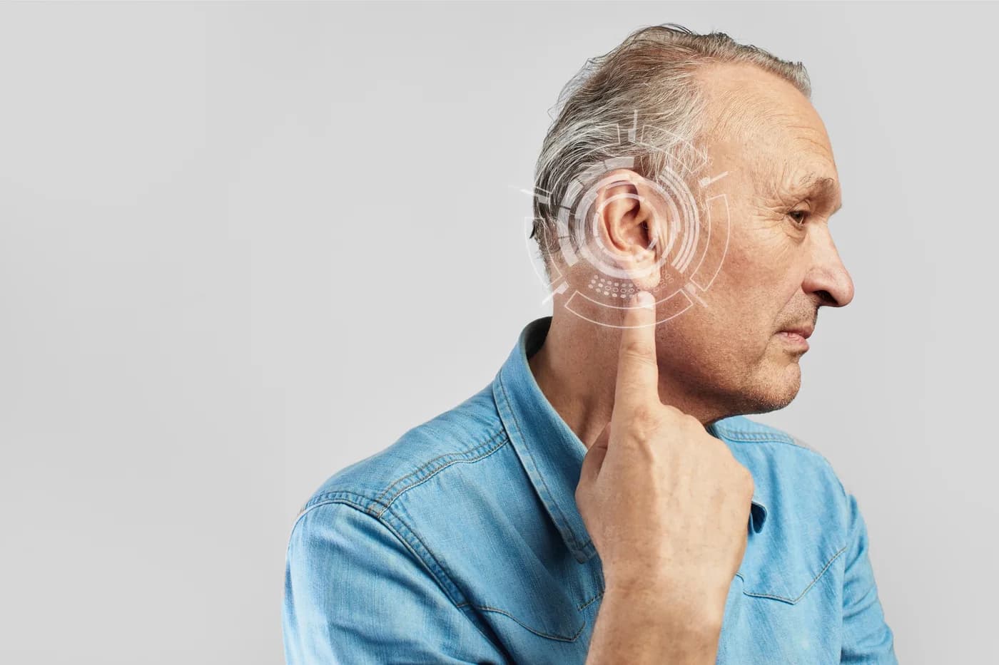 A man touching his ear, with sound waves illustrated around it