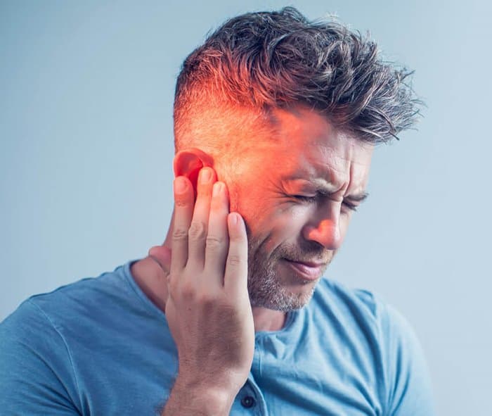 A person experiencing difficulty hearing