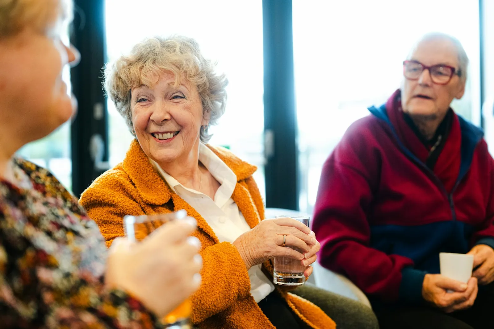 Older adults talking comfortably together in a bright room